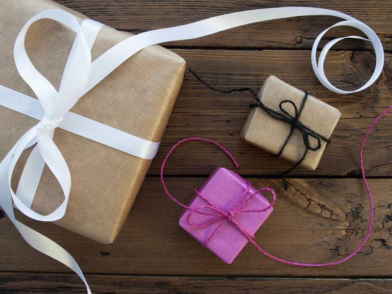 Three Gifts With Ribbons On Wooden Background